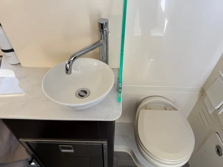 Giddy Up Yacht Photos Pics 2019 Scout 355 LXF CC boat bathroom with modern sink and toilet.