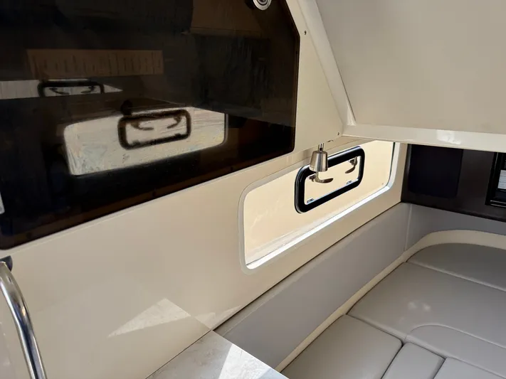Giddy Up Yacht Photos Pics Interior of 2019 Scout 355 LXF CC boat with seating and window.