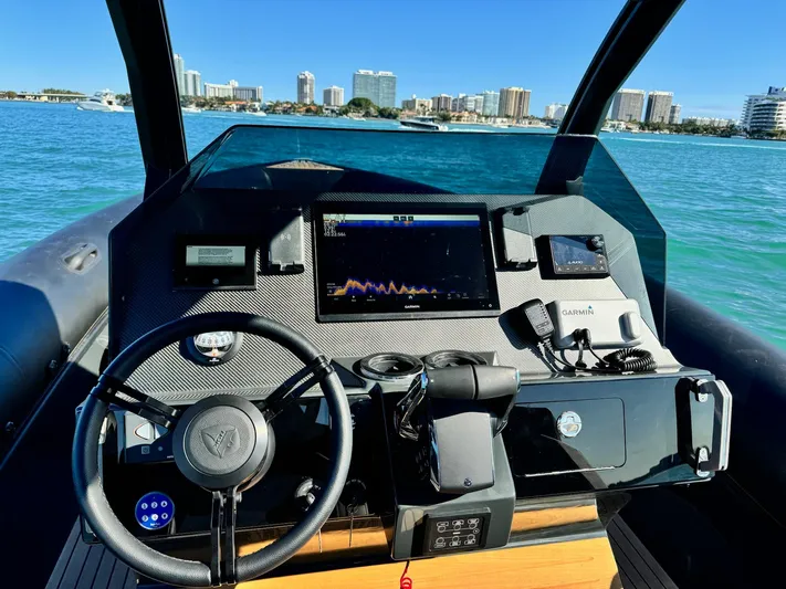 2025 Skipper 34 Twin 300 V8 Yacht Photos Pics Helm of 2025 Skipper-BSK 34 boat with modern navigation equipment, city skyline in background.