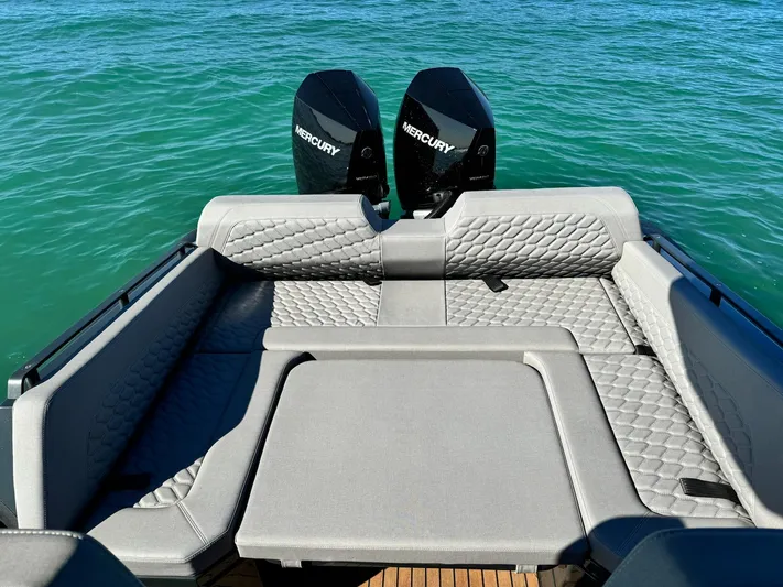 2025 Skipper 34 Twin 300 V8 Yacht Photos Pics 2025 Skipper-BSK 34 boat with Mercury engines, featuring luxurious seating on clear blue water.