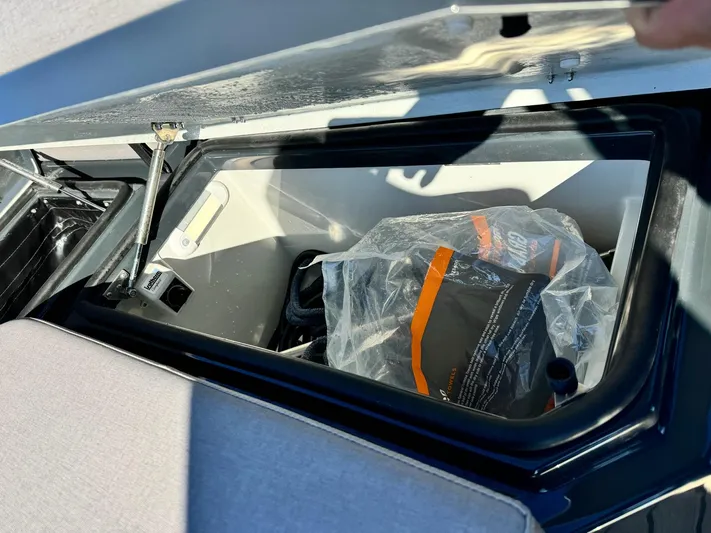 2025 Skipper 34 Twin 300 V8 Yacht Photos Pics Storage compartment in a 2025 Skipper-BSK 34 boat, containing a plastic-wrapped item.