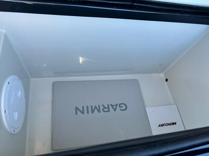 2025 Skipper 34 Twin 300 V8 Yacht Photos Pics Open storage compartment with Garmin and Mercury equipment, Skipper-BSK 34, 2025 model.