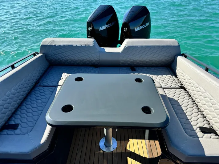 2025 Skipper 34 Twin 300 V8 Yacht Photos Pics Luxurious Skipper-BSK 34 boat interior with seating and table, 2025 model, on turquoise water.