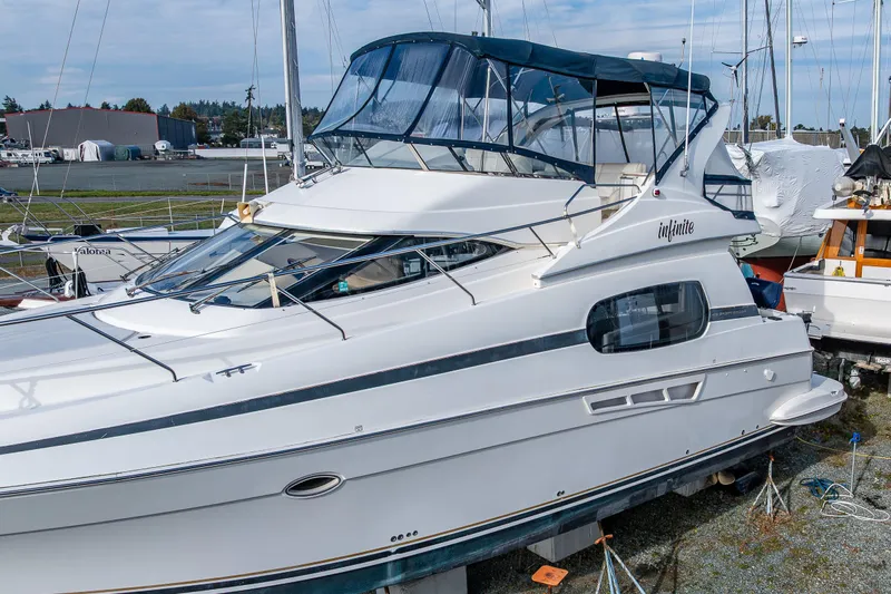 Infinite Yacht Photos Pics 2001 Silverton 410 Sport Bridge yacht docked, featuring sleek design and spacious upper deck.