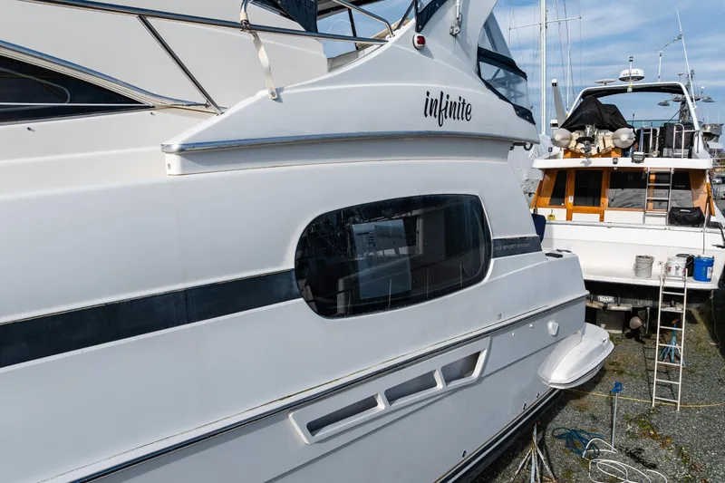 Infinite Yacht Photos Pics 2001 Silverton 410 Sport Bridge yacht docked, featuring sleek design and modern amenities.