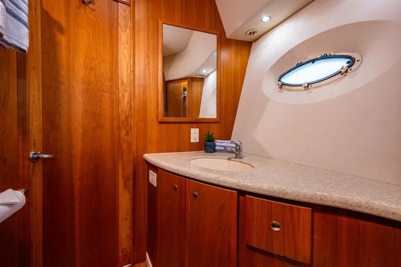 Infinite Yacht Photos Pics Luxurious bathroom interior of 2001 Silverton 410 Sport Bridge yacht with wooden cabinetry.
