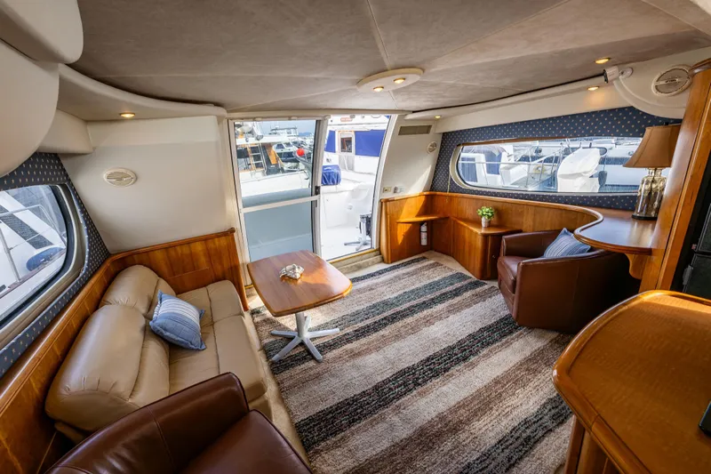 Infinite Yacht Photos Pics Luxurious interior of 2001 Silverton 410 Sport Bridge yacht with elegant seating and decor.
