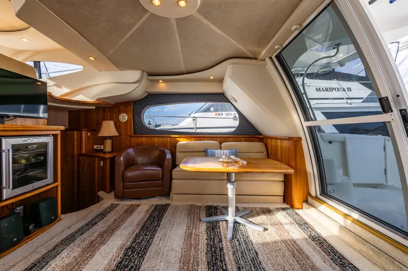 Infinite Yacht Photos Pics Luxurious interior of 2001 Silverton 410 Sport Bridge yacht with cozy seating and elegant decor.