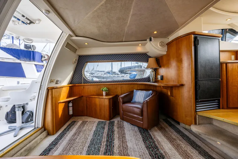 Infinite Yacht Photos Pics Interior of 2001 Silverton 410 Sport Bridge yacht with leather chair and nautical decor.