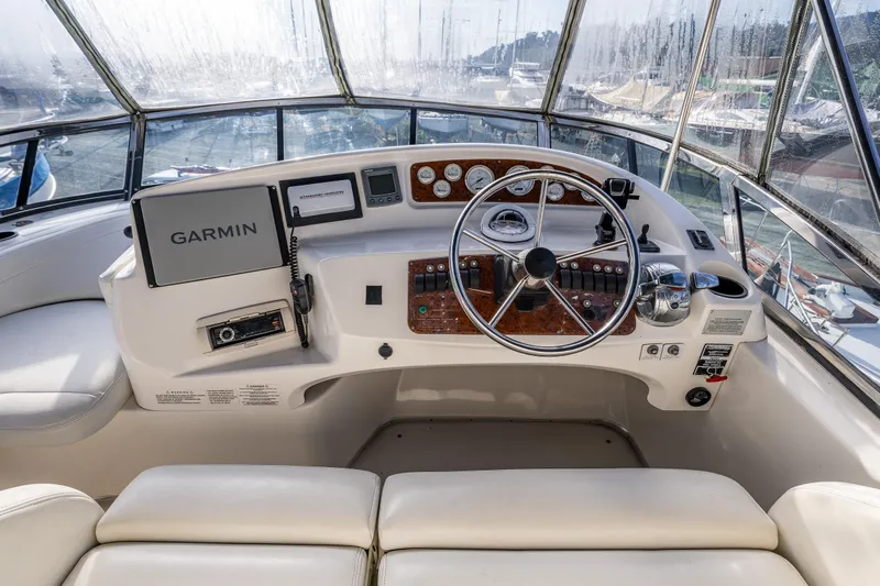 Infinite Yacht Photos Pics 2001 Silverton 410 Sport Bridge helm with Garmin navigation system and luxurious seating.