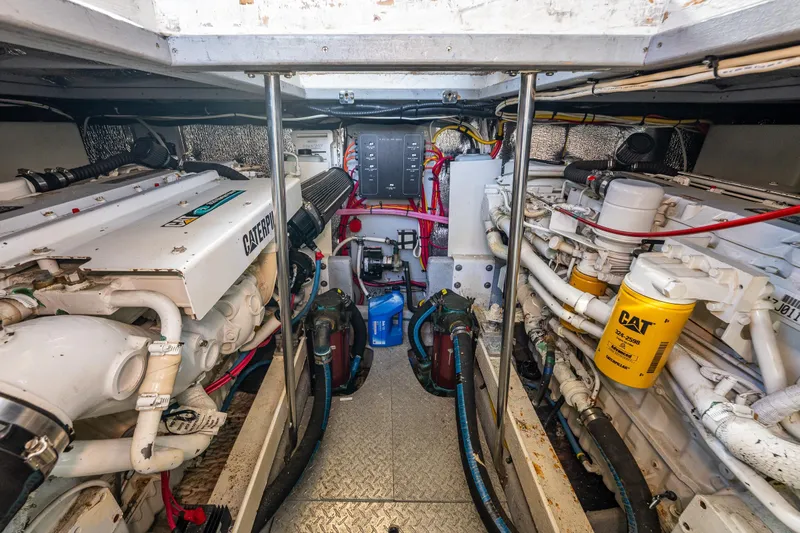 Infinite Yacht Photos Pics Engine room of 2001 Silverton 410 Sport Bridge with Caterpillar engines and mechanical components.