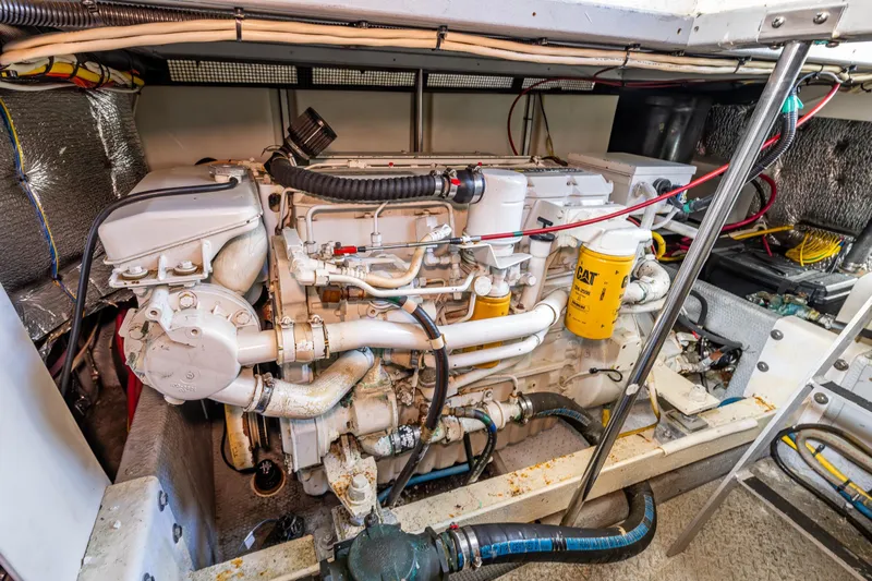 Infinite Yacht Photos Pics Engine room of a 2001 Silverton 410 Sport Bridge yacht, showcasing detailed machinery.