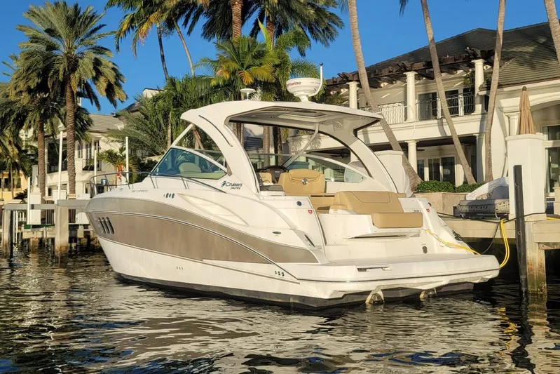  Yacht Photos Pics 2014 Cruisers Yachts 380 Express docked near palm trees and luxury homes.