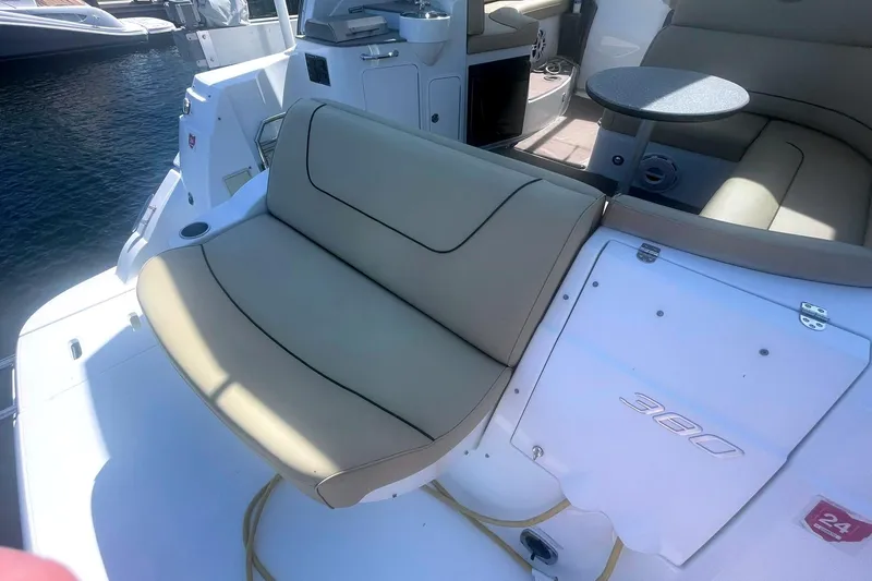  Yacht Photos Pics 2014 Cruisers Yachts 380 Express interior with beige seating and table, docked by the water.