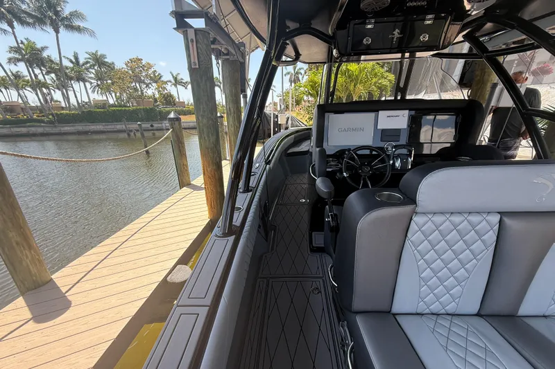  Yacht Photos Pics 2020 Statement 350 Open boat docked by a sunny waterfront with palm trees.
