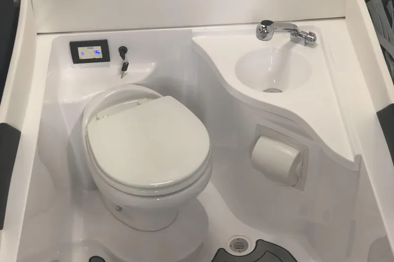  Yacht Photos Pics Compact marine bathroom with toilet, sink, and control panel in a 2020 Statement 350 Open.
