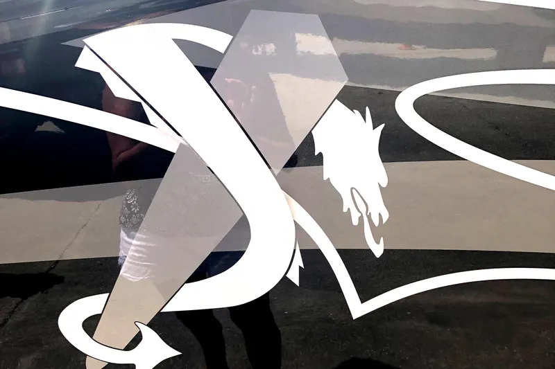  Yacht Photos Pics Decorative logo on a 2020 Statement 350 Open boat, featuring stylized lettering and a dragon motif.