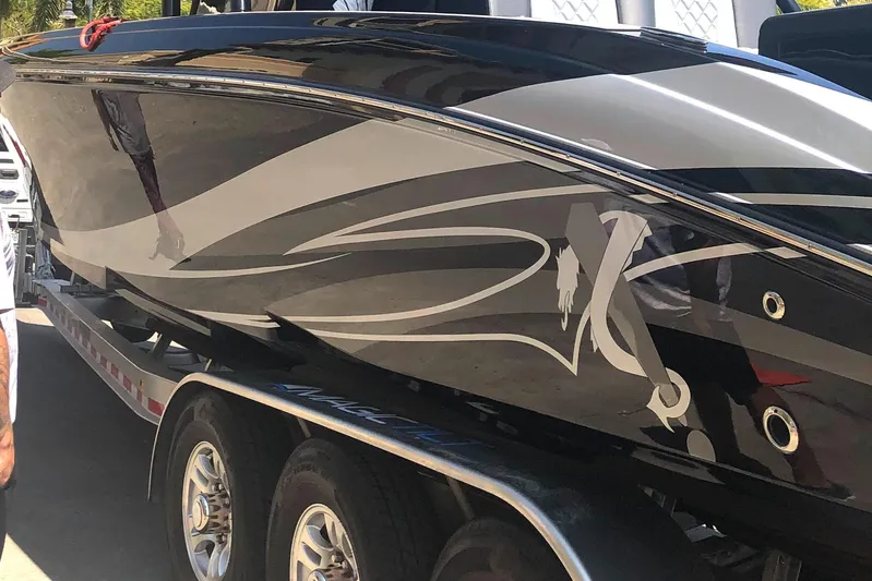  Yacht Photos Pics 2020 Statement 350 Open boat with sleek black and silver design on a trailer.