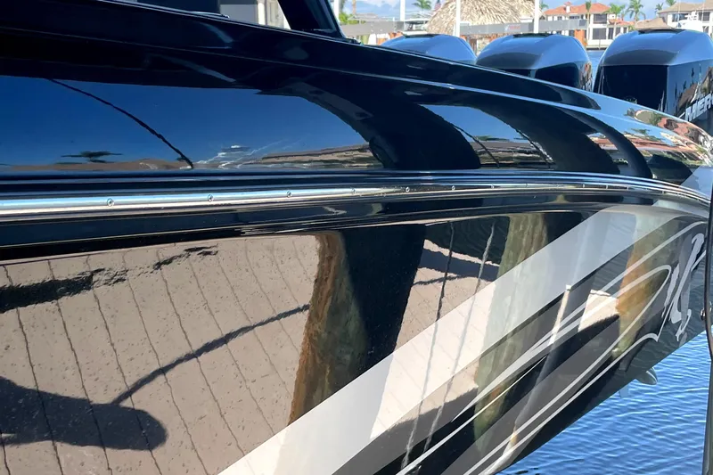  Yacht Photos Pics Sleek black 2020 Statement 350 Open boat with reflective finish docked by the water.