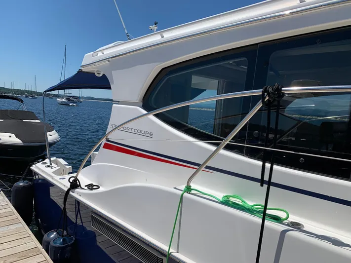 Live Now Yacht Photos Pics 2012 Silverton 33 Sport Coupe docked by the water on a sunny day.