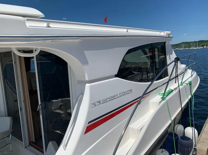 Live Now Yacht Photos Pics 2012 Silverton 33 Sport Coupe yacht docked, featuring sleek design and modern amenities.