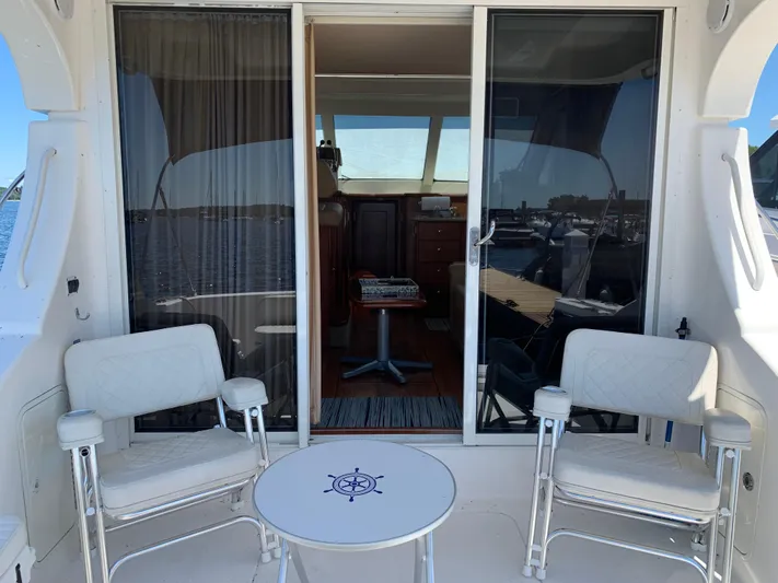 Live Now Yacht Photos Pics 2012 Silverton 33 Sport Coupe yacht interior with chairs and table on deck.