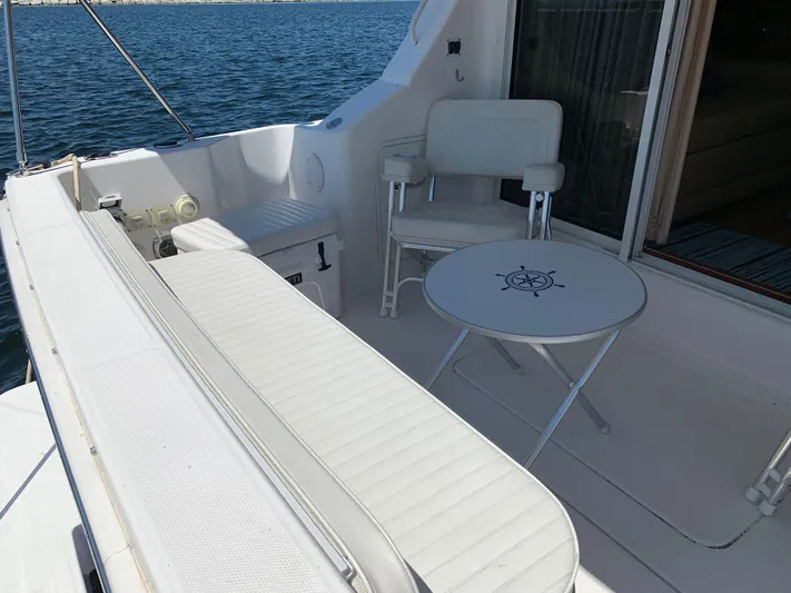 Live Now Yacht Photos Pics 2012 Silverton 33 Sport Coupe boat interior with white seating and nautical-themed table.