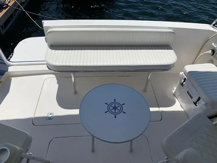 Live Now Yacht Photos Pics 2012 Silverton 33 Sport Coupe boat interior with white seating and nautical-themed table.