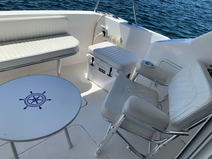 Live Now Yacht Photos Pics 2012 Silverton 33 Sport Coupe boat interior with white seating and nautical-themed table.