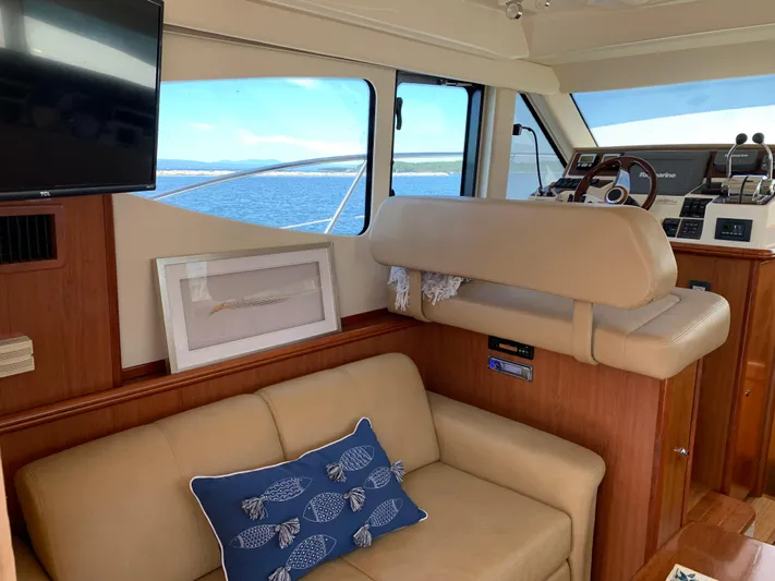 Live Now Yacht Photos Pics Interior of 2012 Silverton 33 Sport Coupe with beige seating and nautical decor.