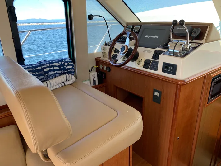 Live Now Yacht Photos Pics Interior helm of 2012 Silverton 33 Sport Coupe with navigation equipment and leather seating.