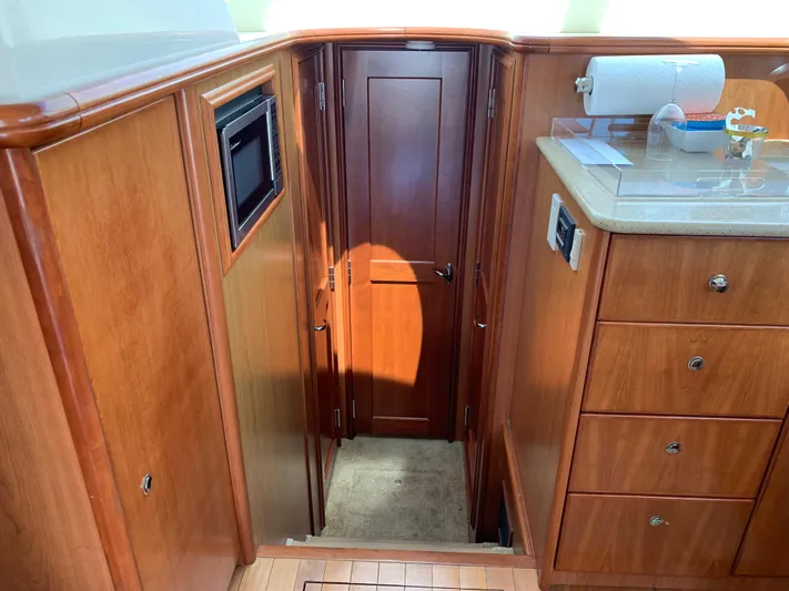 Live Now Yacht Photos Pics Interior of 2012 Silverton 33 Sport Coupe with wood cabinetry and microwave.