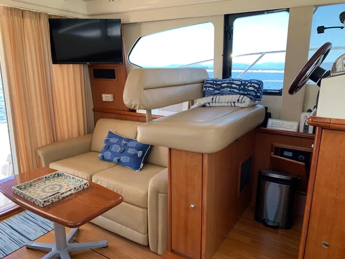 Live Now Yacht Photos Pics Interior of 2012 Silverton 33 Sport Coupe with seating, table, and TV.