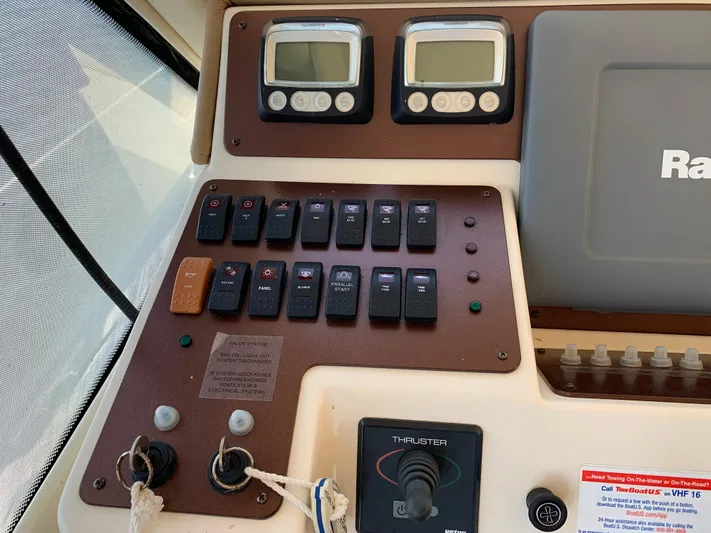 Live Now Yacht Photos Pics Control panel of a 2012 Silverton 33 Sport Coupe boat with switches and gauges.