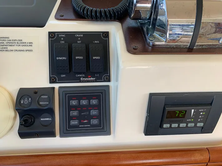 Live Now Yacht Photos Pics Control panel of a 2012 Silverton 33 Sport Coupe with various switches and digital display.