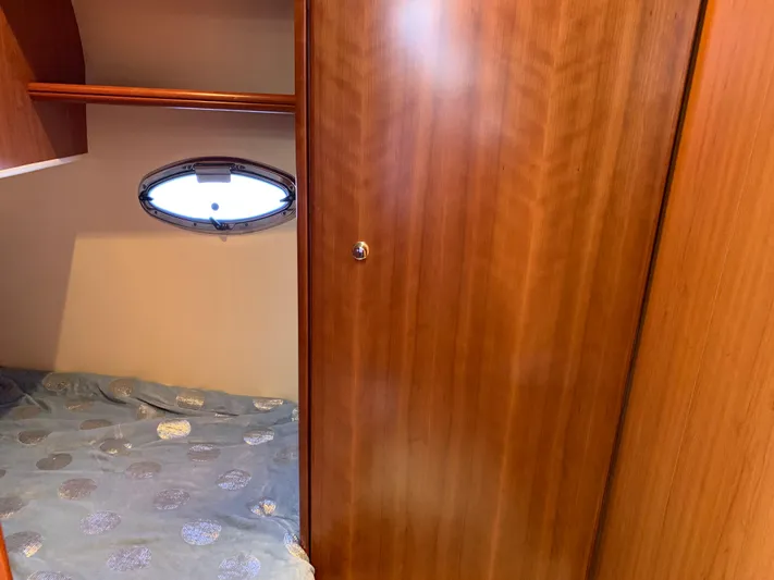 Live Now Yacht Photos Pics 2012 Silverton 33 Sport Coupe cabin interior with wooden paneling and porthole window.