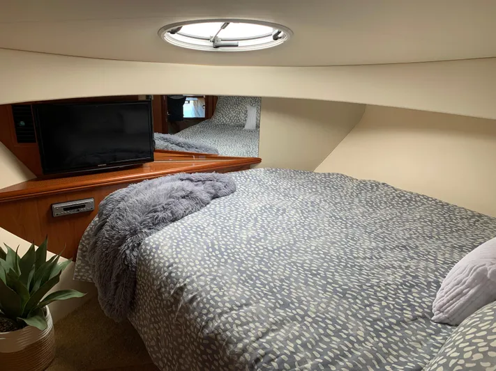 Live Now Yacht Photos Pics Luxurious interior of 2012 Silverton 33 Sport Coupe with cozy bedding and modern amenities.