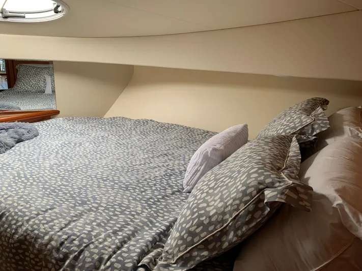 Live Now Yacht Photos Pics Cozy bedroom interior of 2012 Silverton 33 Sport Coupe yacht with patterned bedding.