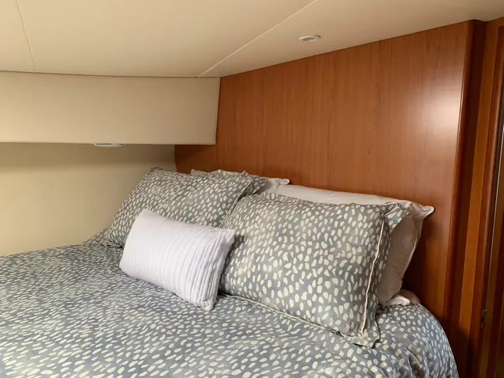 Live Now Yacht Photos Pics Cozy bedroom interior of 2012 Silverton 33 Sport Coupe with patterned bedding.