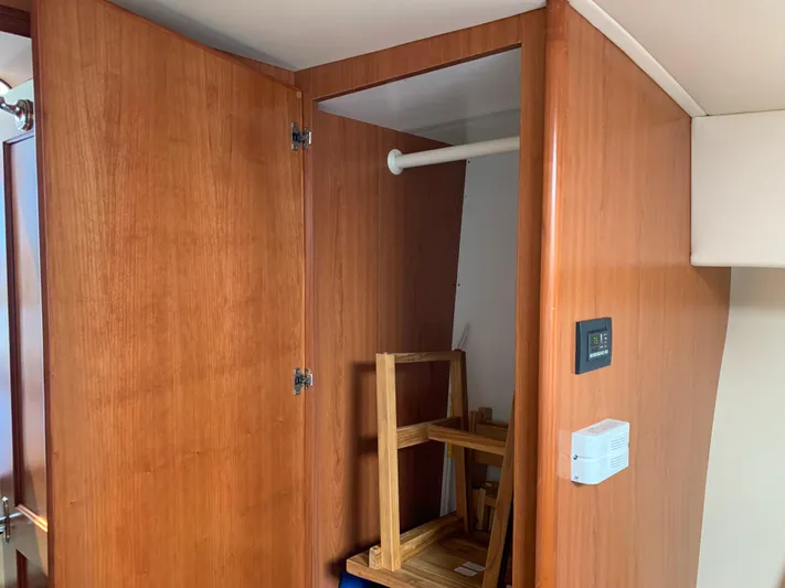 Live Now Yacht Photos Pics Interior wooden closet in 2012 Silverton 33 Sport Coupe yacht, featuring open door and shelving.
