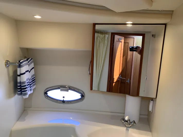 Live Now Yacht Photos Pics Bathroom interior of 2012 Silverton 33 Sport Coupe with mirror and towel.