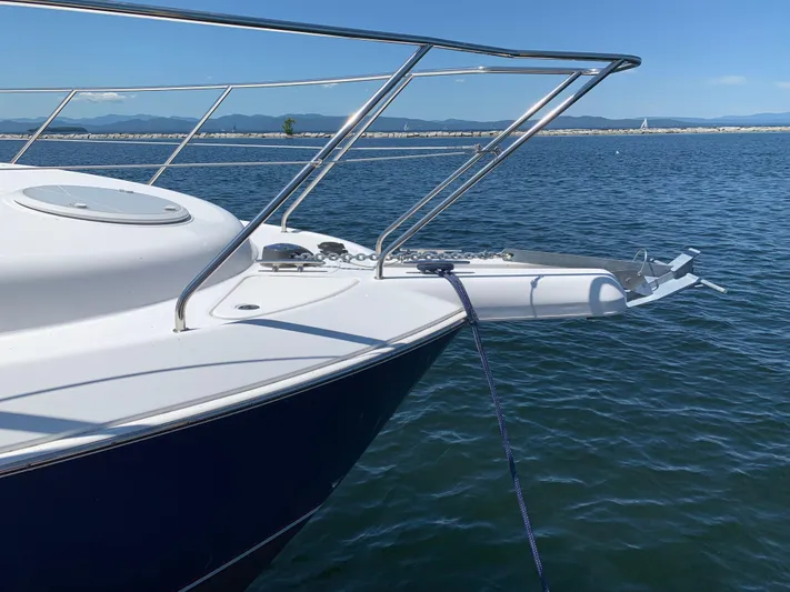 Live Now Yacht Photos Pics 2012 Silverton 33 Sport Coupe yacht anchored on calm blue water.