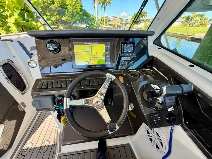  Yacht Photos Pics 2019 Blackfin 272 DC boat dashboard with steering wheel, navigation screens, and controls.