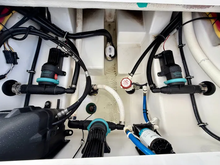  Yacht Photos Pics Engine compartment of a 2019 Blackfin 272 DC boat, showcasing pumps and wiring.