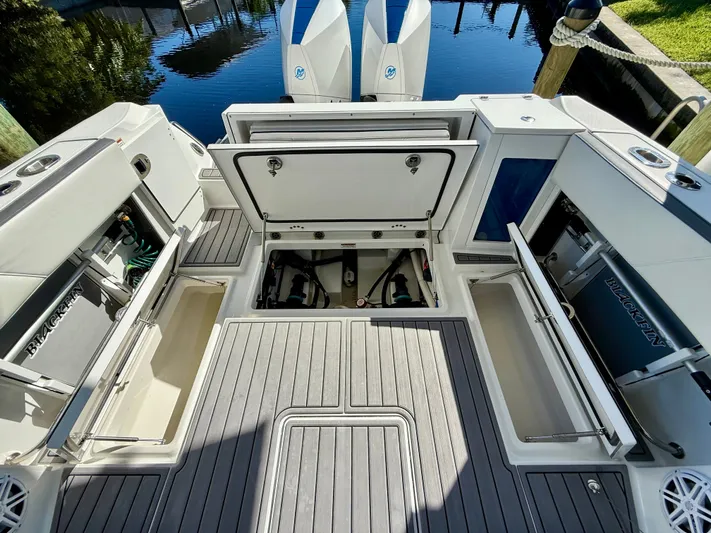  Yacht Photos Pics 2019 Blackfin 272 DC boat deck with open storage compartments and twin engines.