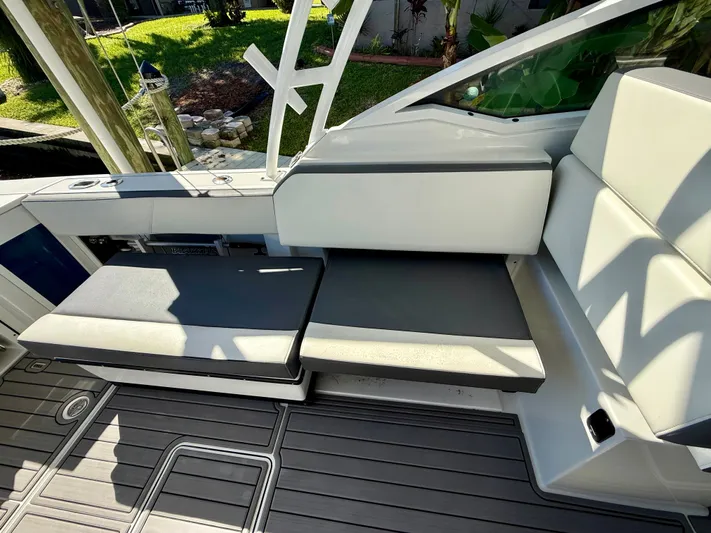  Yacht Photos Pics 2019 Blackfin 272 DC boat interior with cushioned seating and sleek design.