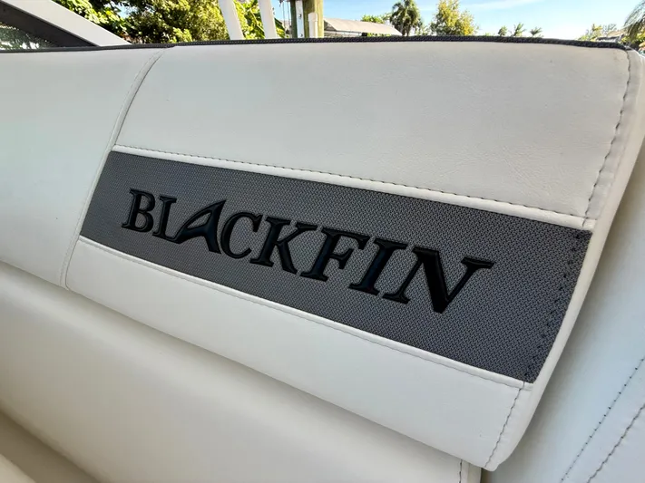  Yacht Photos Pics Blackfin 272 DC 2019 boat seat with logo, featuring white and gray upholstery.