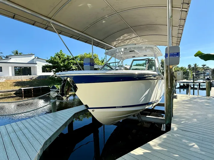  Yacht Photos Pics 2019 Blackfin 272 DC boat docked under a canopy on a sunny day.