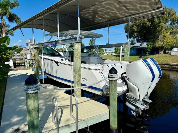  Yacht Photos Pics 2019 Blackfin 272 DC boat docked under canopy, featuring dual outboard engines.
