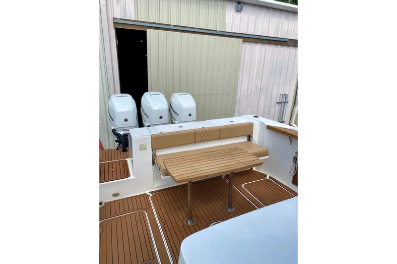  Yacht Photos Pics 2023 Fishing Raptor 390 Solarium boat with wooden deck and triple outboard engines.